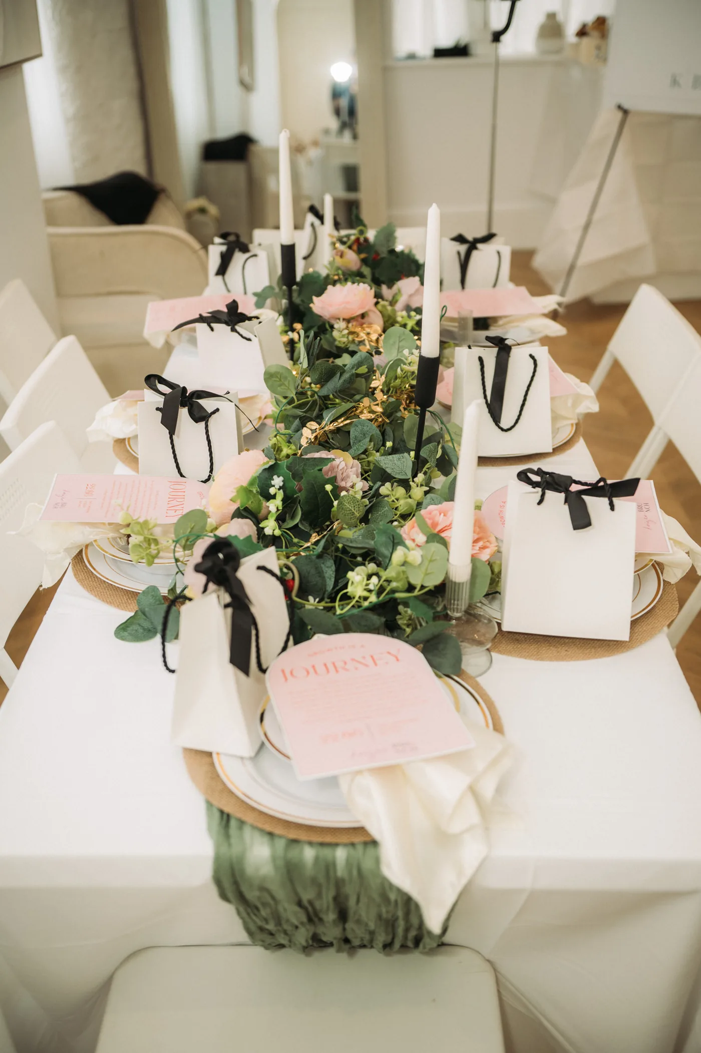 The Pre-Launch gathering table, styled with florals and gift bags